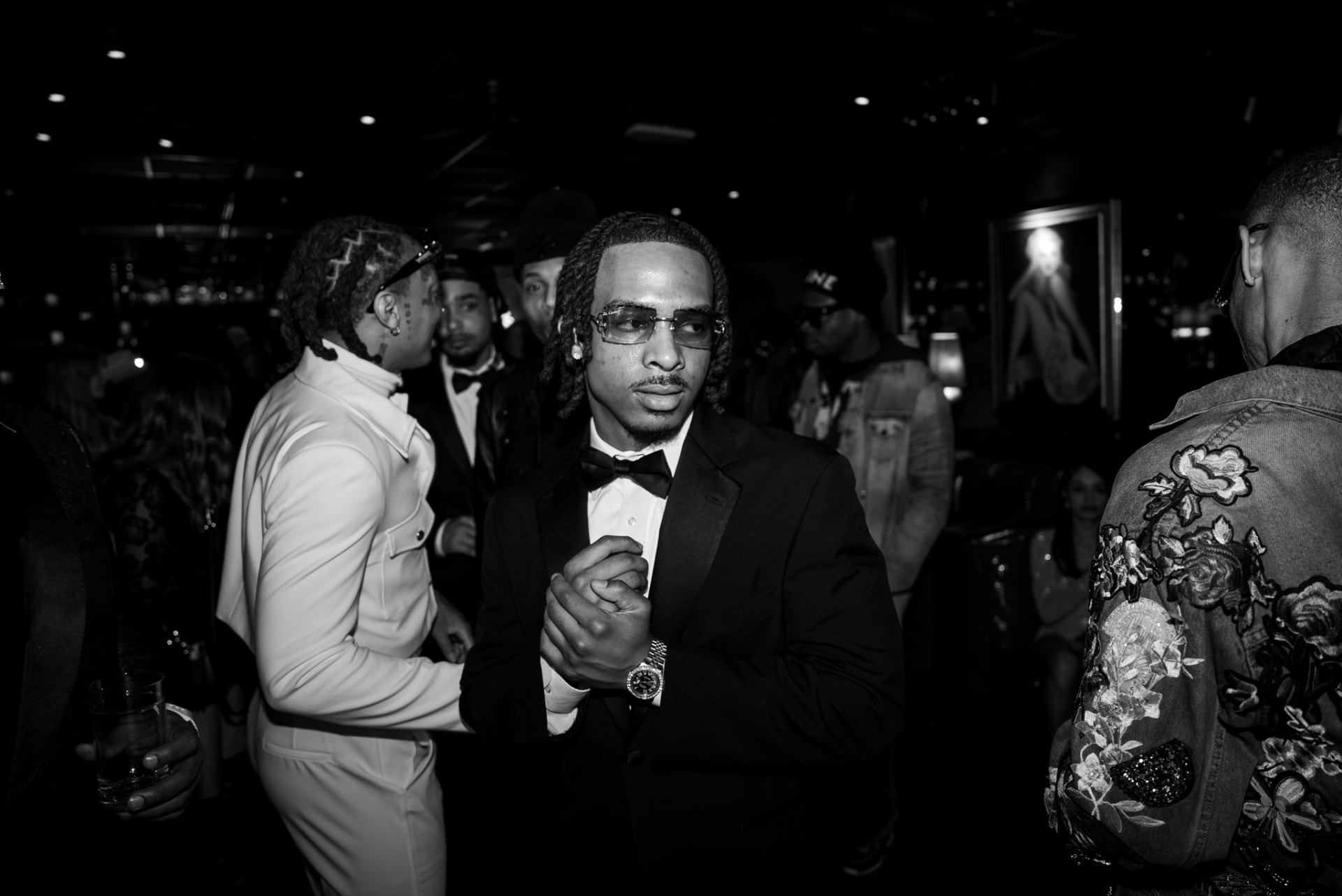 Black-and-white photo of a man in a tuxedo at a formal event