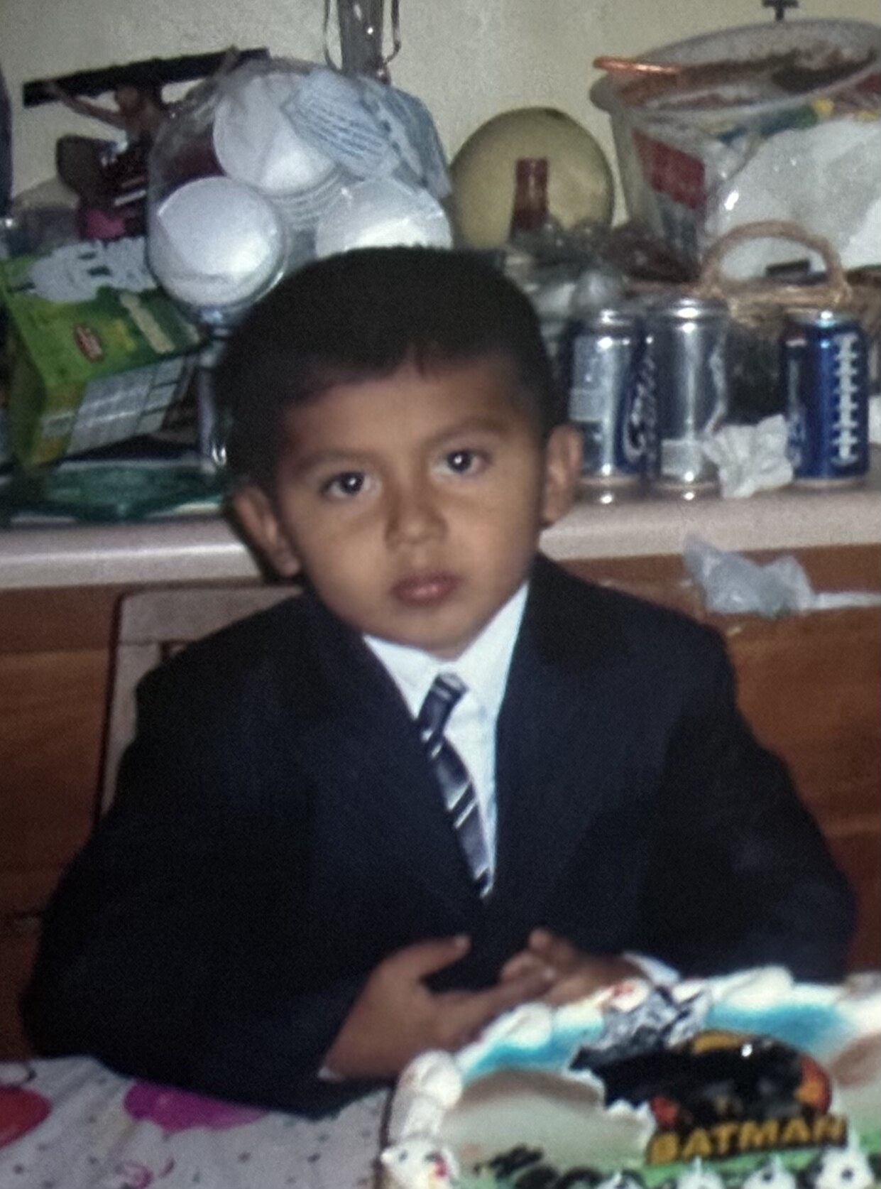 Childhood portrait in a suit at a birthday celebration