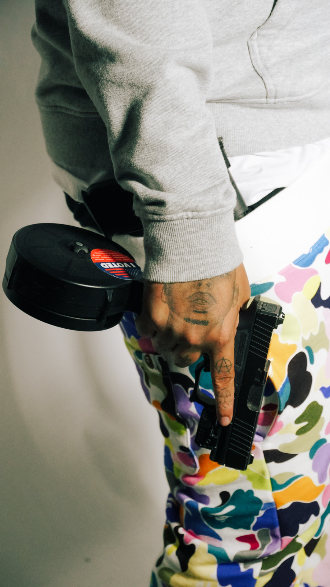 Detail shot of camo pants and a gray hoodie on set