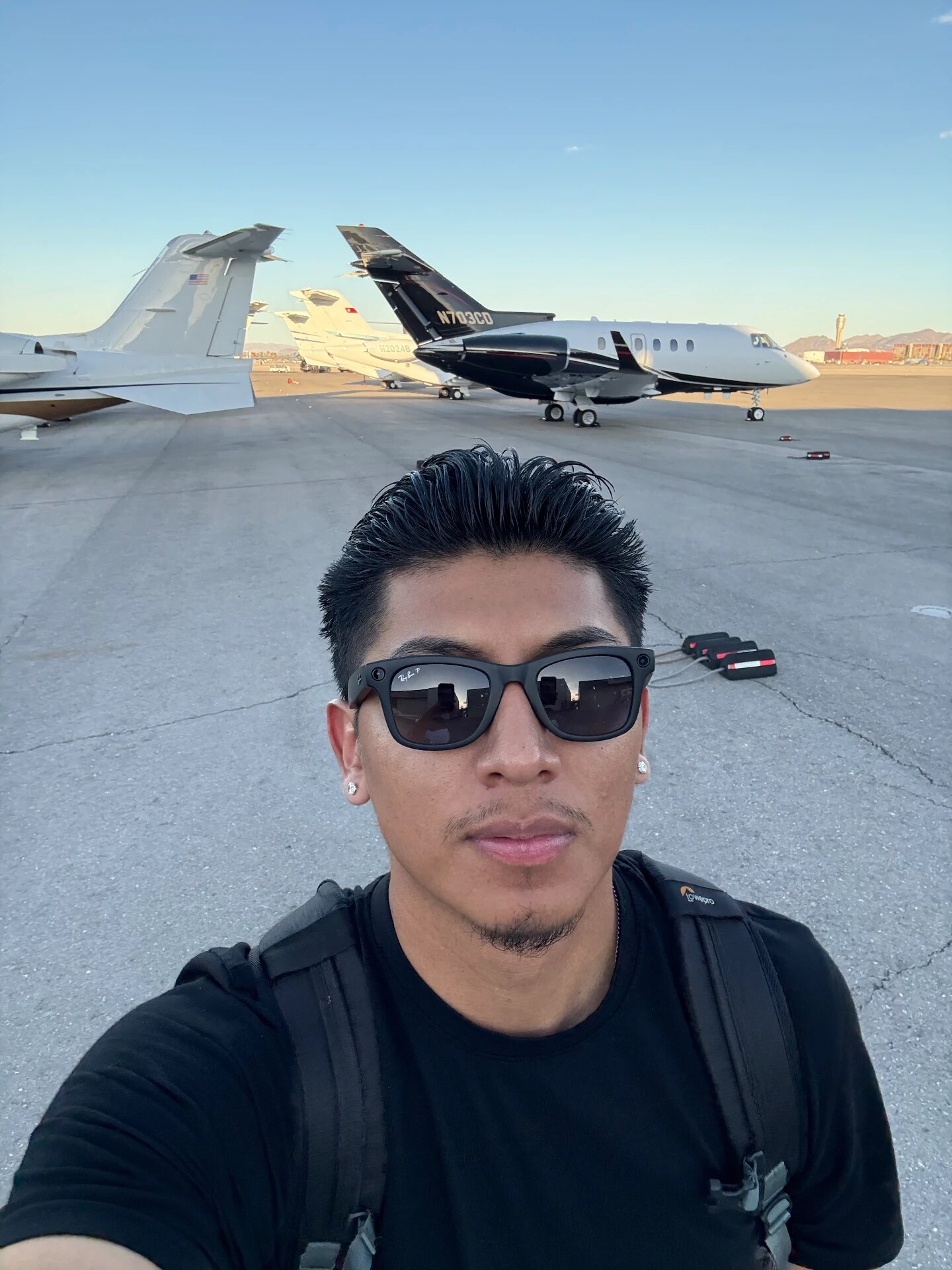 On the tarmac beside private jets