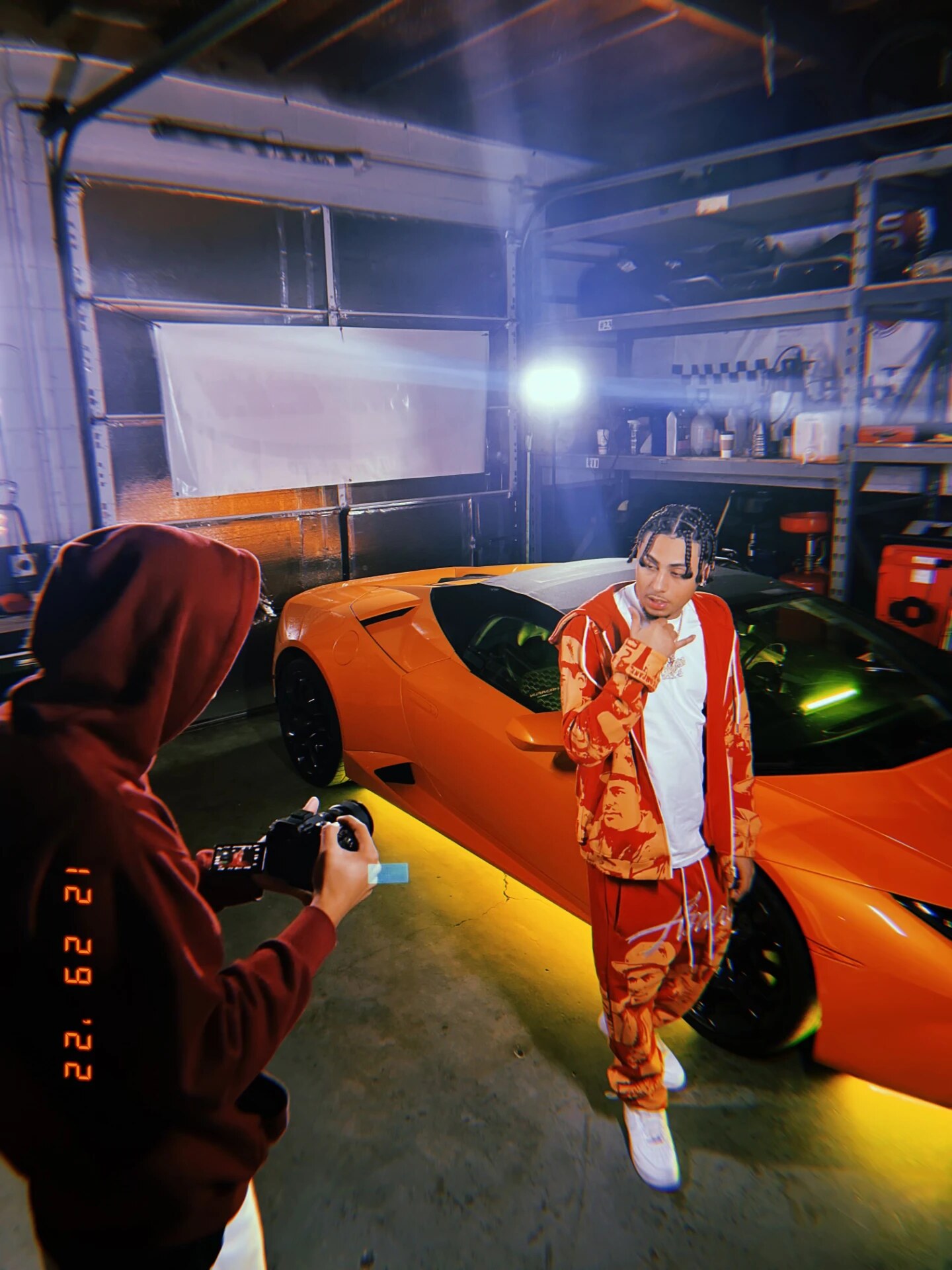 Shooting an artist beside an orange Lamborghini